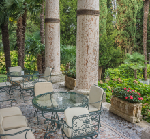 Patio at the Villa Cortine Palace Hotel in Sirmione, Italy. The building materials and details, furniture, and view each contribute to the biophilic experience of the space.